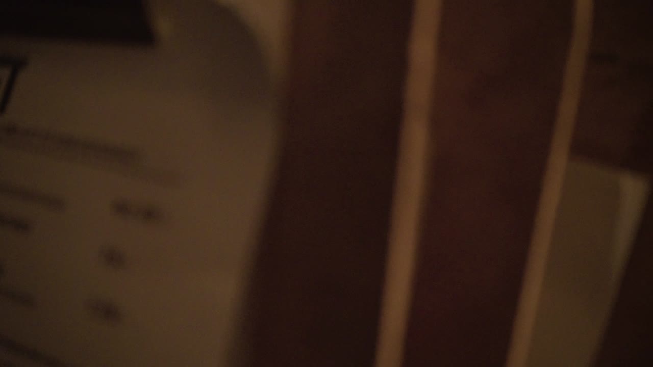 Close-up of many old documents in a wooden rack