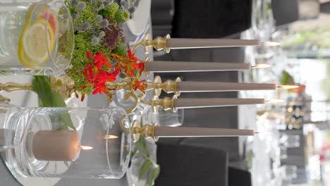 decorative candle stand and flower bouquet on wedding table, vertical