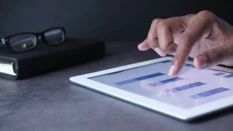 business person analyzing data on a tablet