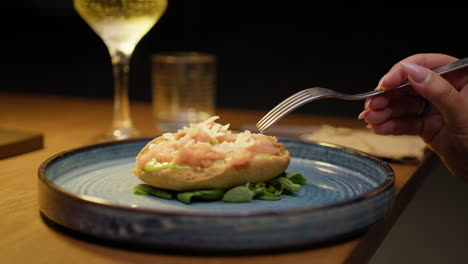 small kind of gourmet pizza with fish inside a blue dish at the restaurant