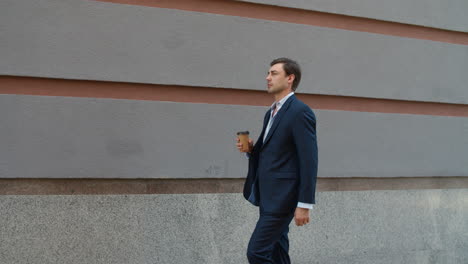 Side-view-man-drinking-coffee-to-go.-Man-going-to-work-with-coffee-outdoor