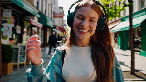 happy woman walking in city with headphones