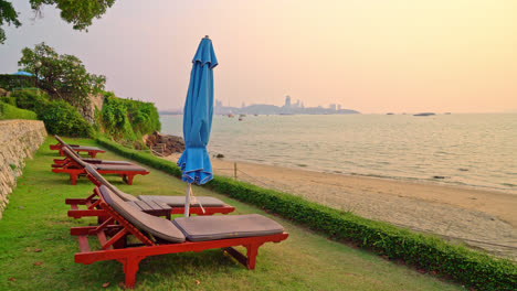 beach chair or pool bed and umbrella with sunset and sea background