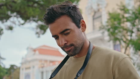 handsome reporter taking picture beautiful city area summer day close up.