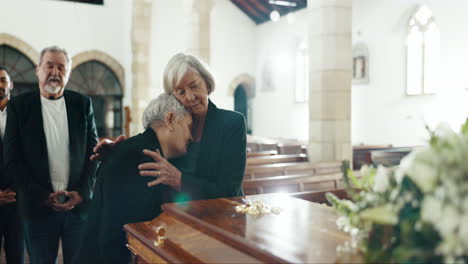 Senior-women,-hug-and-funeral-in-church