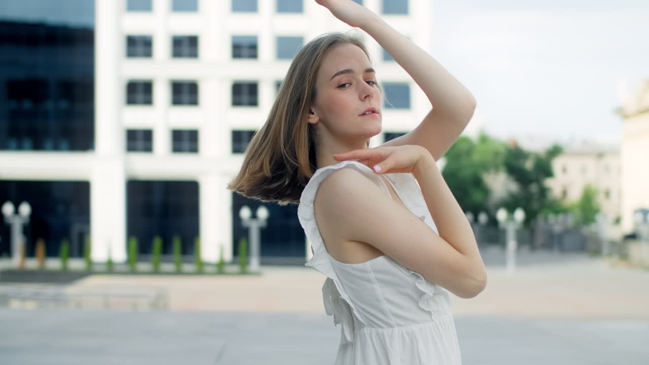 Young Woman Posing in White Dress Outdoors