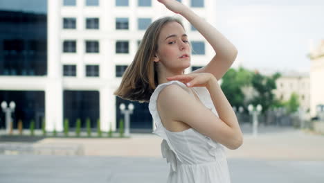 young woman posing in white dress outdoors