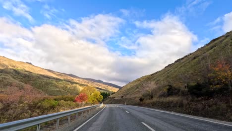 a 20-second drive through wanaka's vibrant autumn scenery, showcasing colorful foliage, clear skies, and winding roads