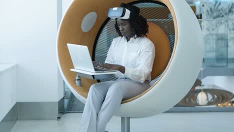 serious businesswoman with laptop and vr headset