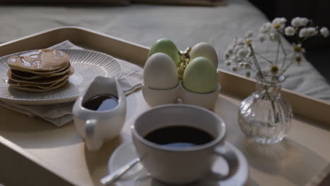 easter breakfast tray with pancakes, eggs, and coffee