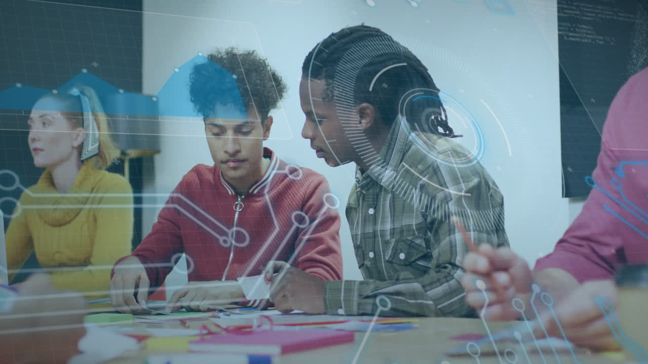 Collaborating on project, two young men using animation and digital data in school