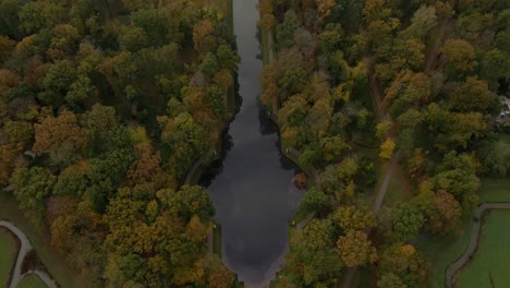 Aerial-at-Kruisvijver-with-forest-revealing-Castle-De-Haar-in-Holland