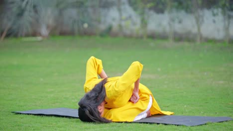 indian girl doing forward bending yoga pose