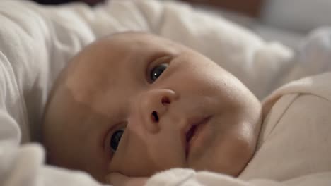 adorable beautiful newborn baby boy lying in cot