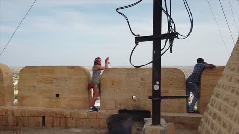 tourist looking out over jaisailmer, rajasthan, india.