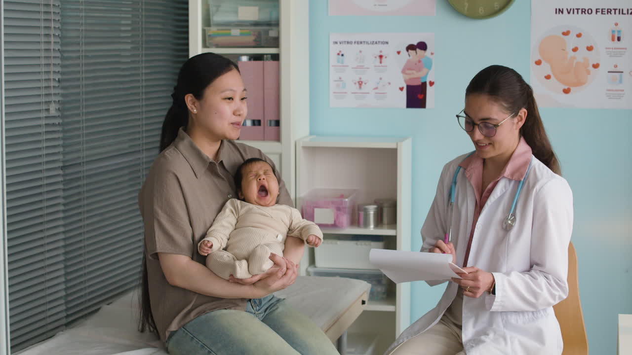 Mother and baby with doctor in clinic