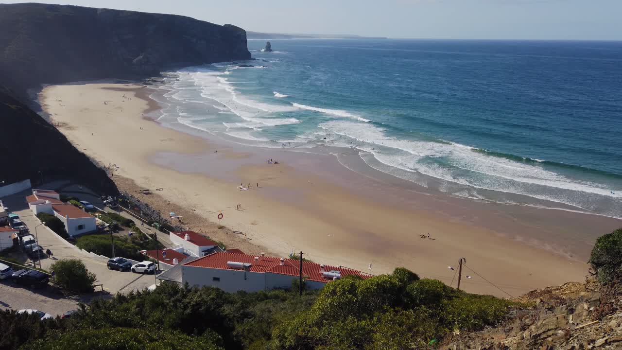 panning shot above the praia do arrifana at the algarve in portugal
