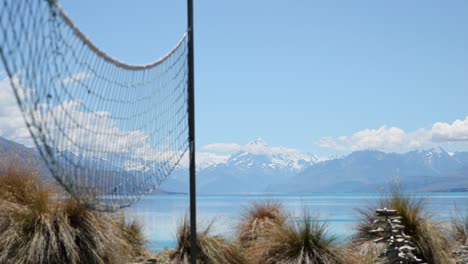 Red-De-Voleibol-Moviéndose-En-El-Viento-Con-El-Impresionante-Monte-Cook-Y-El-Lago-Pukaki-En-Segundo-Plano