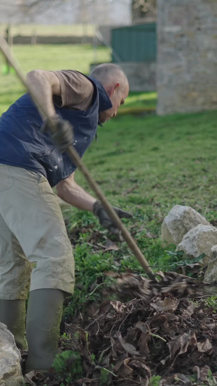 Man raking leaves in the garden