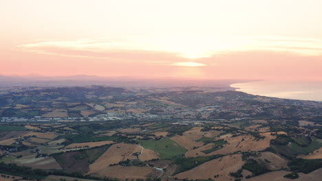 Aerial-drone-view-of-hills-and-agricultural-fields-in-Marche-region,-Italy