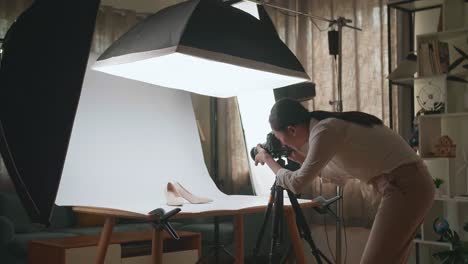 asian female photographer thinking while taking photos of them in home studio