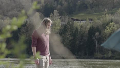 blonde-young-man-staring-down-and-walks-lightely-out-of-the-camera