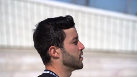 Side-view-of-focused-bearded-man-running-outdoor