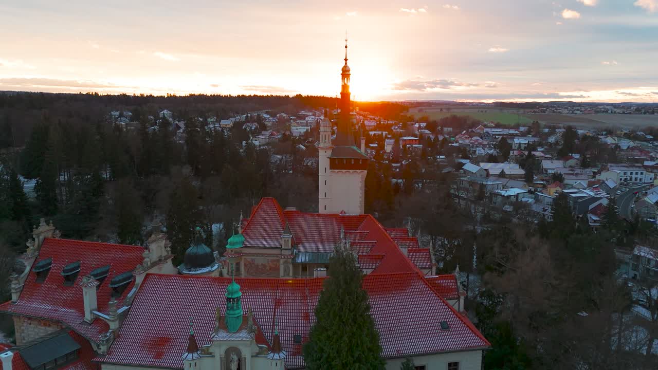 Aerial - Pruhonice castle at sunset with golden light near horizon, Czechia