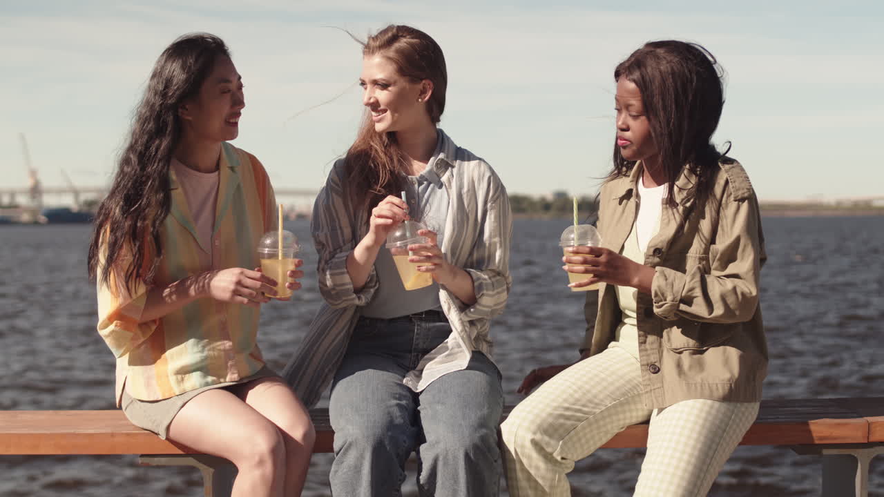 Multiethnic Girlfriends Chatting at Waterfront