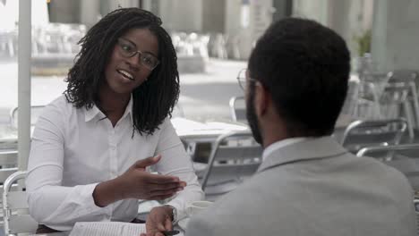 confident employees talking and shaking hands.