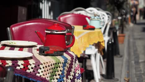 outdoor cafe scene with vintage teapot