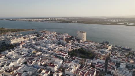 ayamonte, spain: orbiting shot above traditional white buildings on seaside