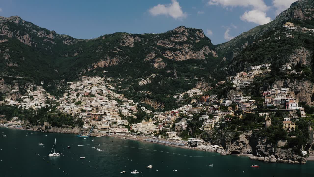 Drone shot pulling away from Italy's Positano on a sunny day