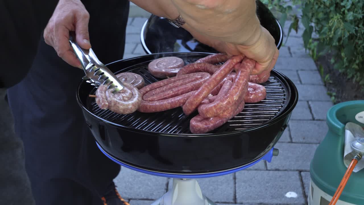 Extended grilled sausages on a barbeque stove in slow motion