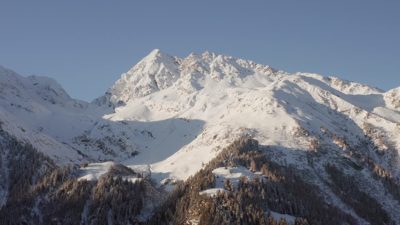 Aerial hyper lapse of a snow covered mountain in the French Alps