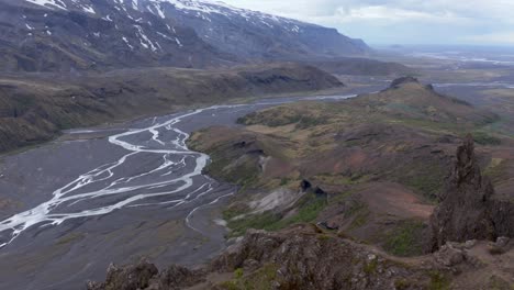 meandering krossá river in magical thorsmork valley on cloudy day, aerial