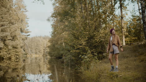 woman running on grass by lake in forest