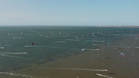 kite surfing on the scenic sea in brouwersdam, netherlands - aerial drone shot