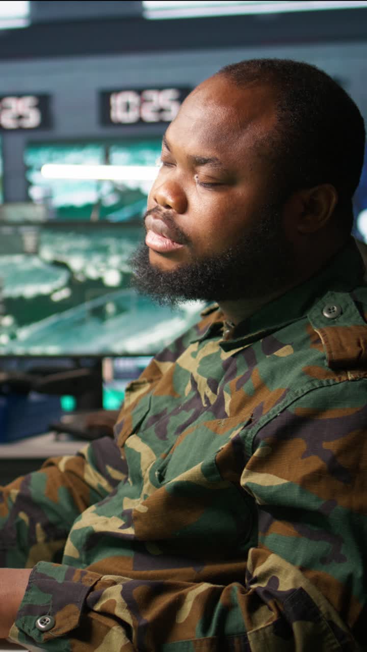 Vertical video Exhausted intelligence corps agent controlling drones, working overtime
