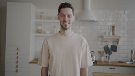 man smiling in a kitchen