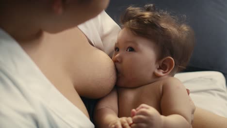 close up and high angle of asian baby breastfed by mother.