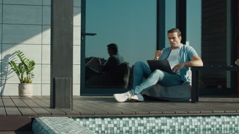 sadness man looking laptop outside home. sad person having business trouble