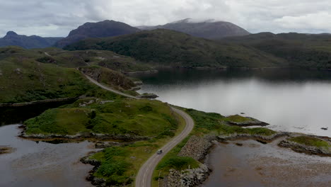 aerial shot of winding road near the kylesku bridge in north-west scotland that crosses the loch a' chàirn bhàin in sutherland