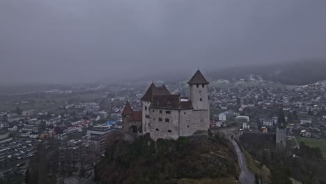 A-medium-distance-orbital-shot-of-Gutenberg-Castle,-with-the-village-of-Balzers-in-the-background