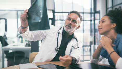 a-mature-medical-doctor-examining-an-xray