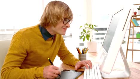 young creative businessman drawing on graphic tablet