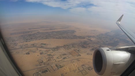 airplane window view above the city