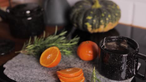 Hot-orange-tea-infusion-in-a-cup-close-up,-organic-citrus-naturopathy-drink-with-selective-focus-background