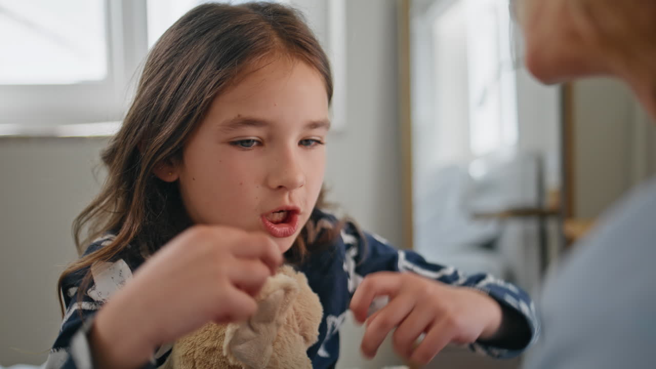 Cute toddler talking mom room closeup. Child communicating unrecognizable mother