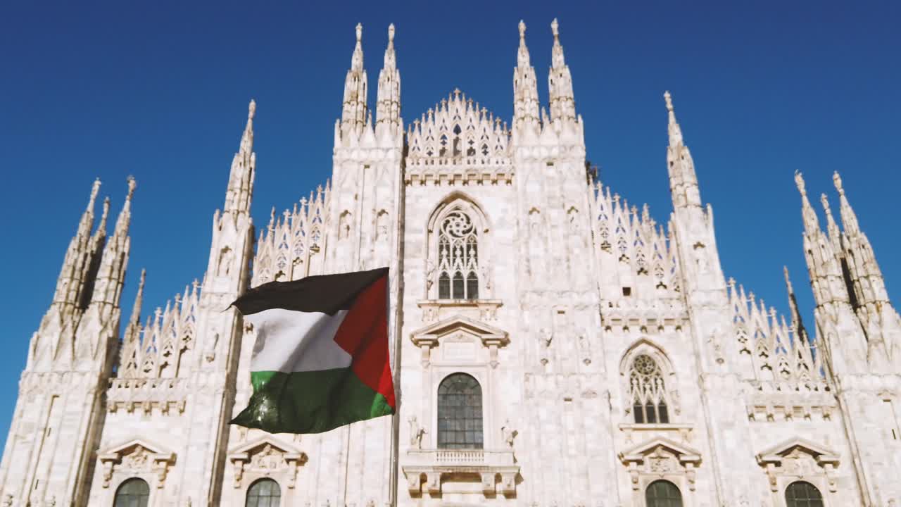 Palestine flag waves over Duomo Cathedral in Milano Italy during a Protest